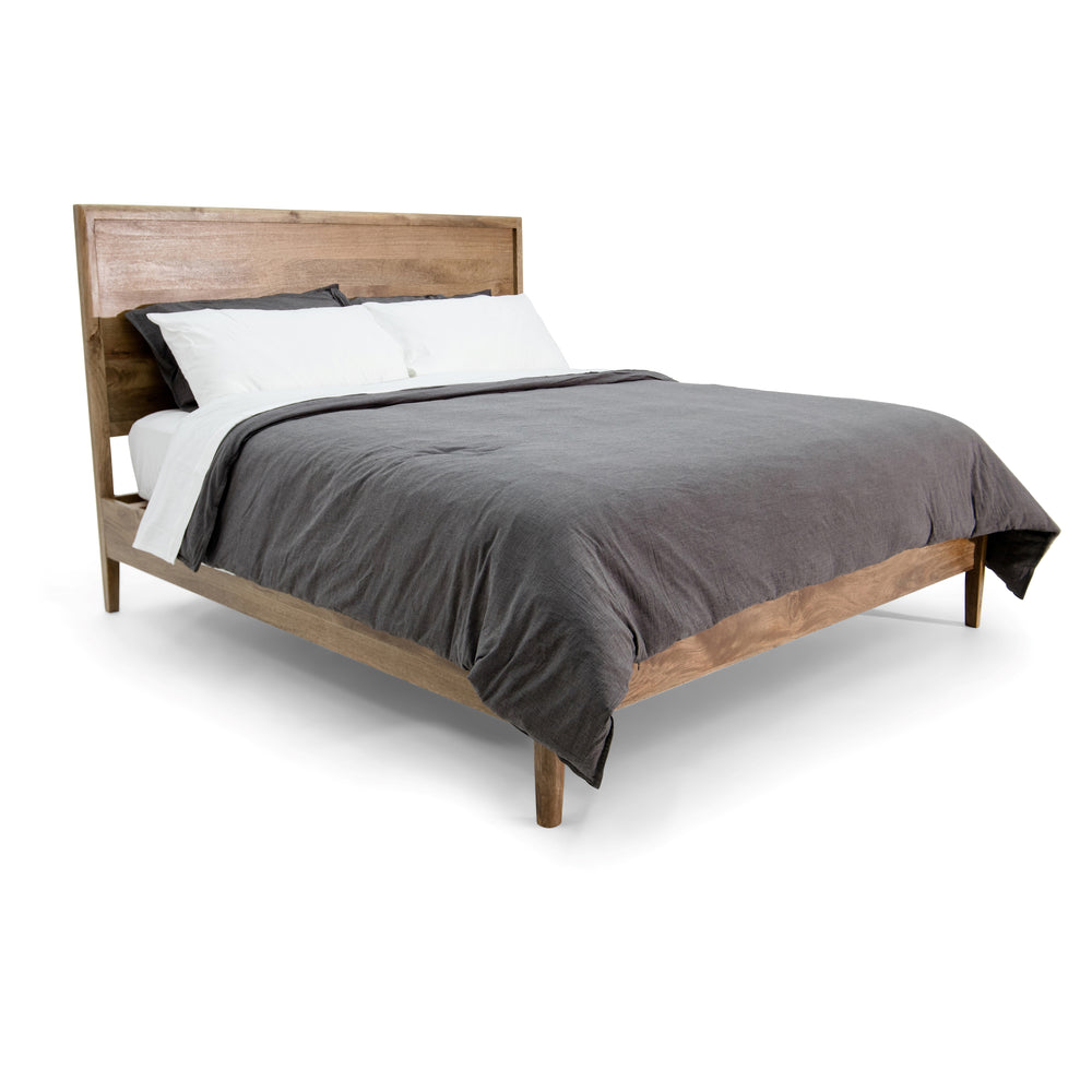 Brown Corwin Panel Bed with pillows and a blanket on a white background