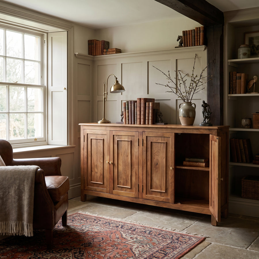 Cozy home library with a wooden sideboard, leather armchair, and classic decor in a warm, traditional interior.